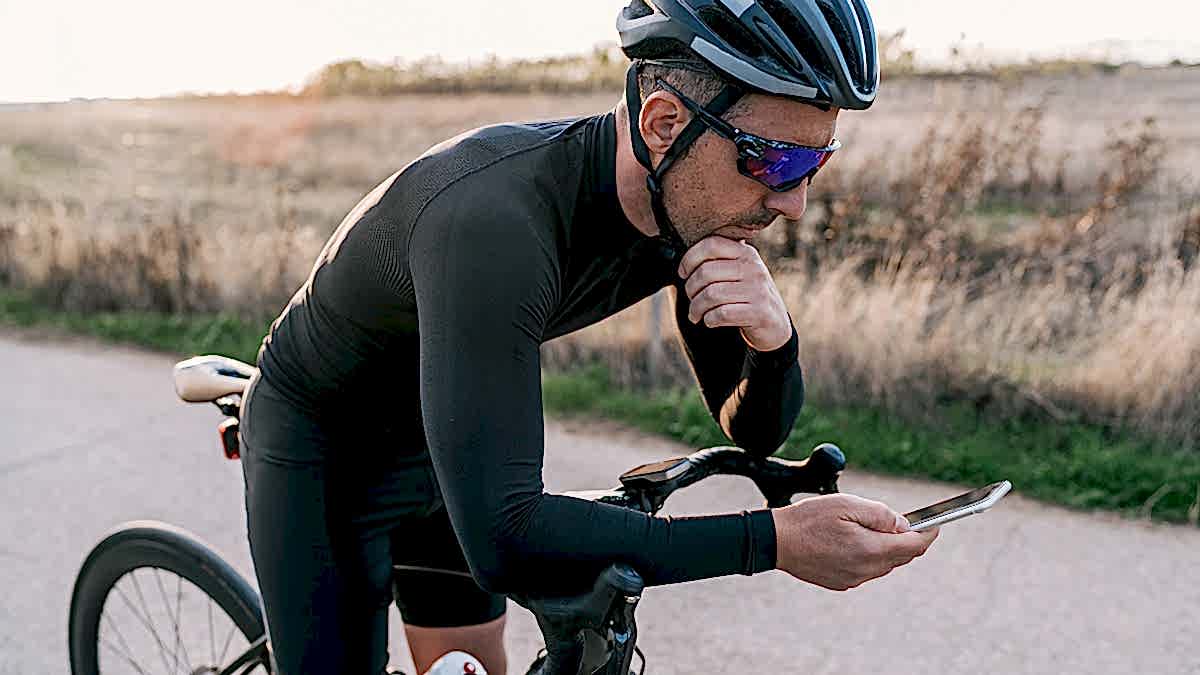 Image Of A Male Cyclist Taking A Break From His Ride To Look At Andy Coggan's Cycling Power Zones In Trainingpeaks