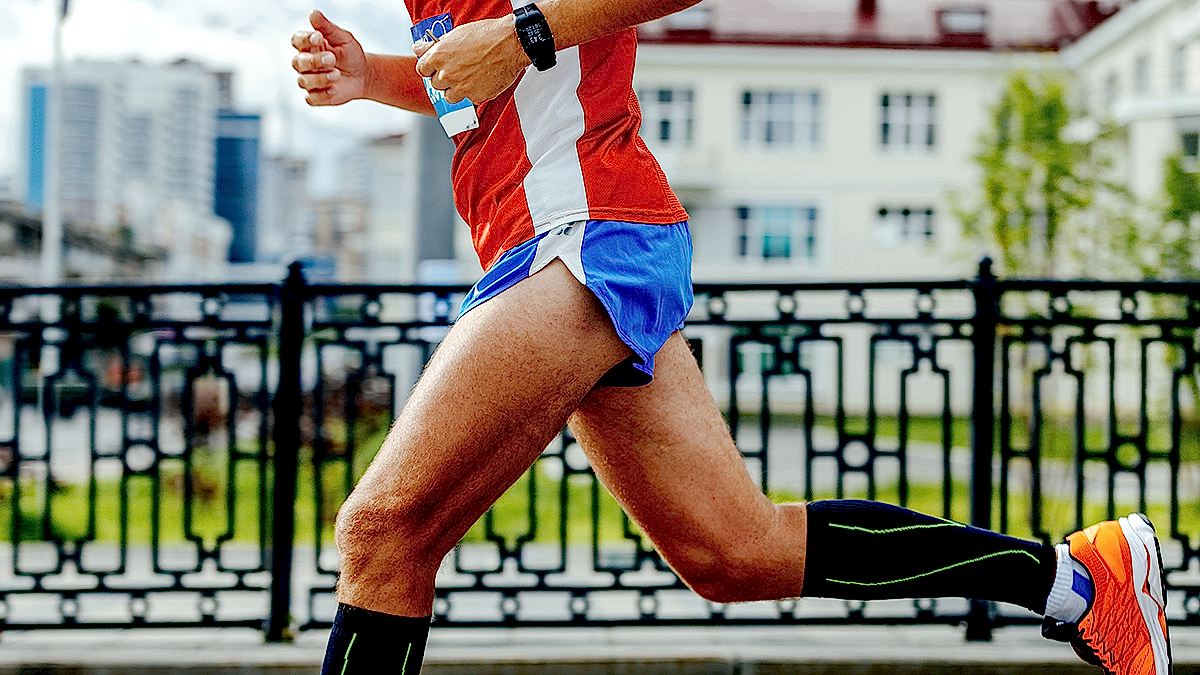 Image Of A Man Jogging Strong In Urban Area After Completing These Essential Hip Strengthening Exercises For Runners