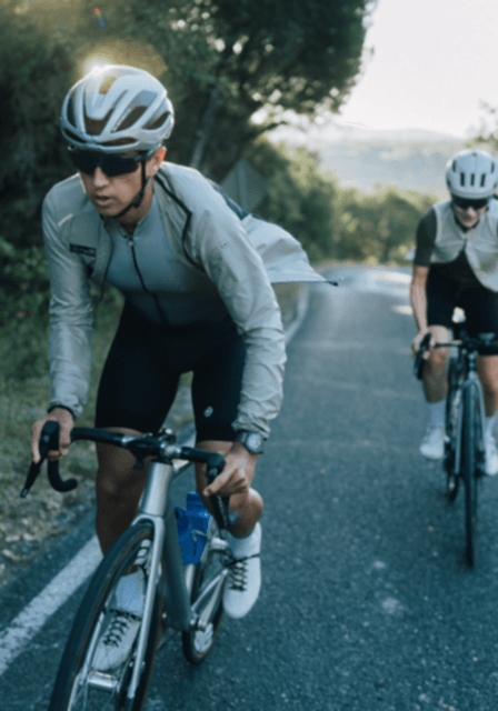 Cyclists Riding On Road